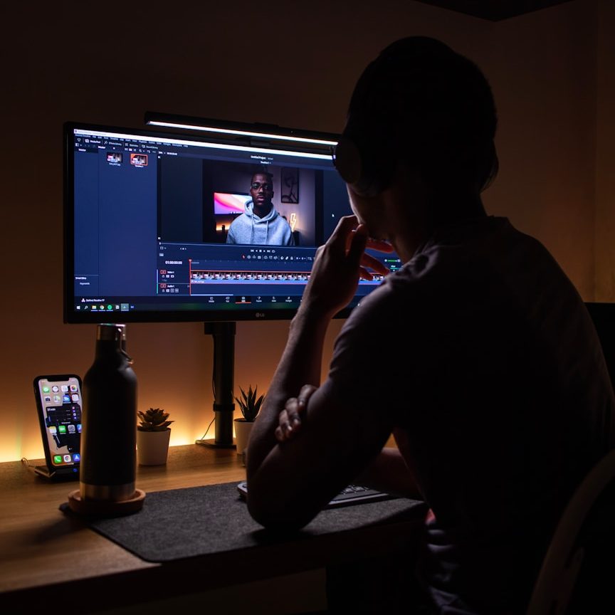 This is a stock image of a random guy editing a video on his computer